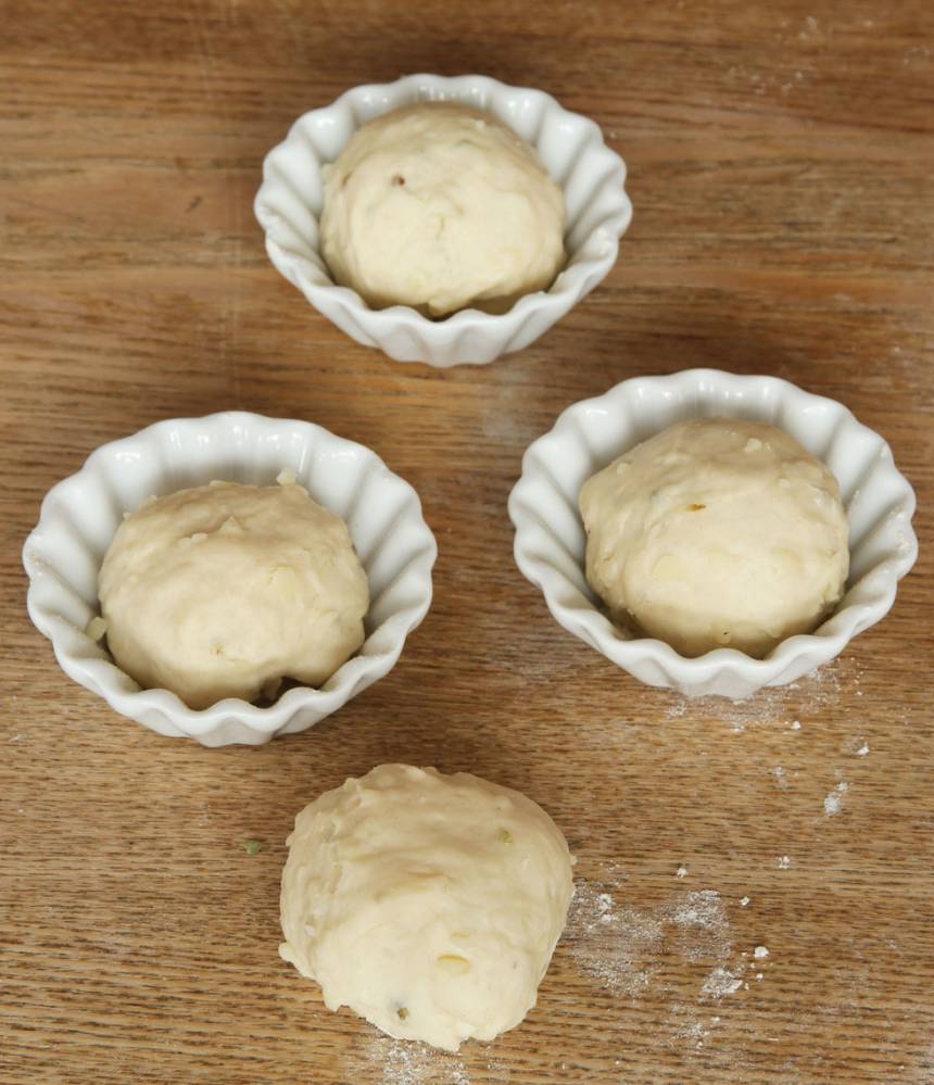 2. Dela degen i ca 16 bitar. Forma runda bollar och lägg dem i muffinsformar av porslin (behöver mjölas) eller papper. Ställ formarna på en ugnsplåt. Låt bröden jäsa under bakduk i ca 30 min. Sätt ugnen på 250 grader. 