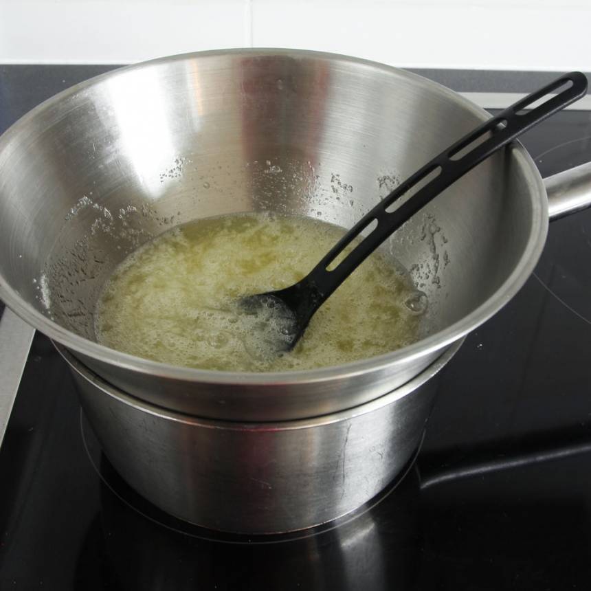 3. Ställ skålen över ett lätt kokande vattenbad. Rör om hela tiden tills sockerkristallerna smält. Ta bort skålen direkt när de smält. 