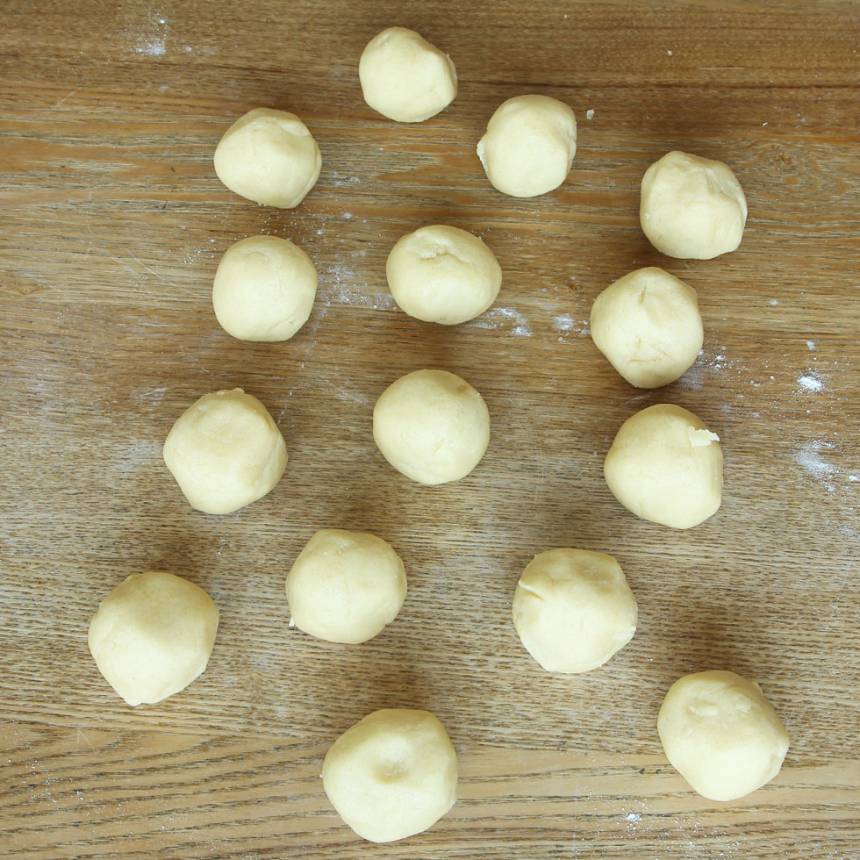 2. Dela degen i ca 30 lika stora bitar. Rulla dem till bollar och lägg dem på en plåt med bakplåtspapper. 